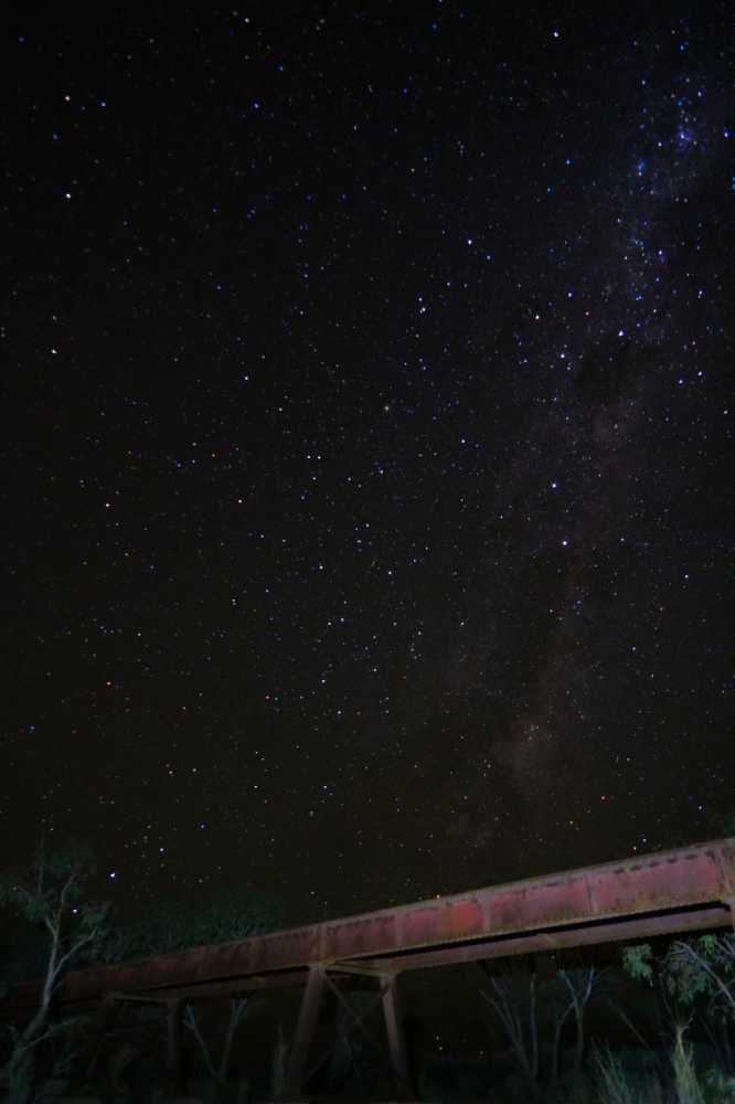 the old Ghan railway bridge under the night sky