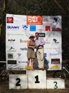 Jude on the top spot of the podium getting her prize from Paul Sherwen
