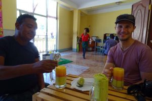 Jon and Mengistu enjoying a 'spri' - a layered drink of pureed fruit (avocado, papaya and mango), Jude is having an avocado juice.