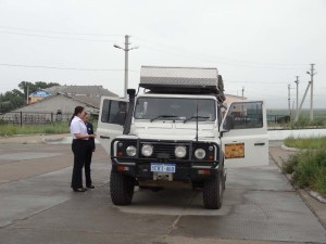 Lara being checked by a customs official on the Mongolian - Russian border