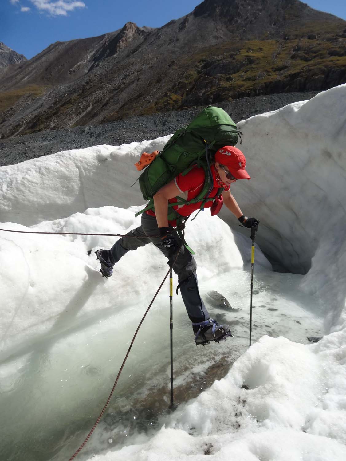 crampons and big backpack make it difficult to cross small streams