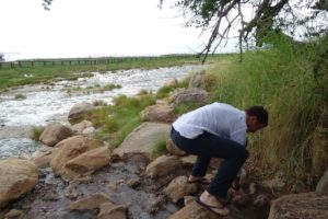 Jon checking out the temperature of the hot springs (Maji Moto) in Lake Manyara NP