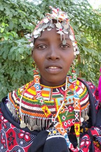 this 14 year old Rendille girl got married a few weeks ago to a 14 year old warrior from her tribe and is therefore still wearing her beautiful decorations. Her 4 month old child hangs on her side, shotgun wedding?