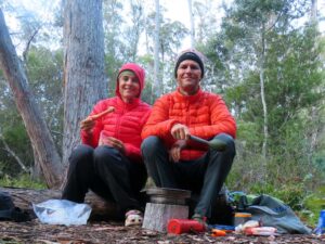 Jon and Jude enjoying pre-dinner carrots with homemade hummus whilst waiting for the dehydrated meal to re-hydrate. It's very cold at our first campsite and we're wearing all the warm clothes we brought