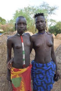 two young Mursi women showing their beauty scars