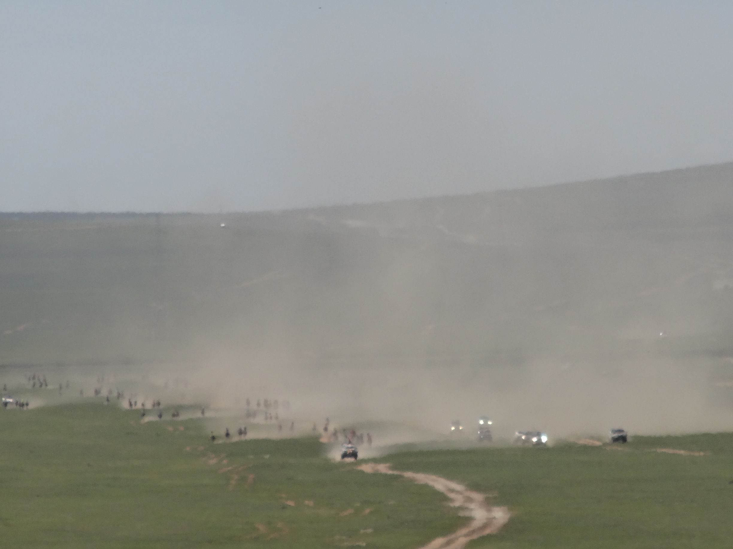 a little closer and the cloud of dust reveals horses and 4WDs 