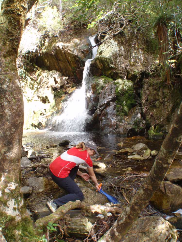 Jude filling up the bladder, the water is so clean here in the Tasmania wilderness you can drink it straight from the creeks