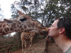 Jon giving the giraffe a kiss