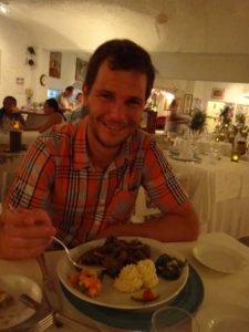 Jon eating the local speciality - fruit bat stew