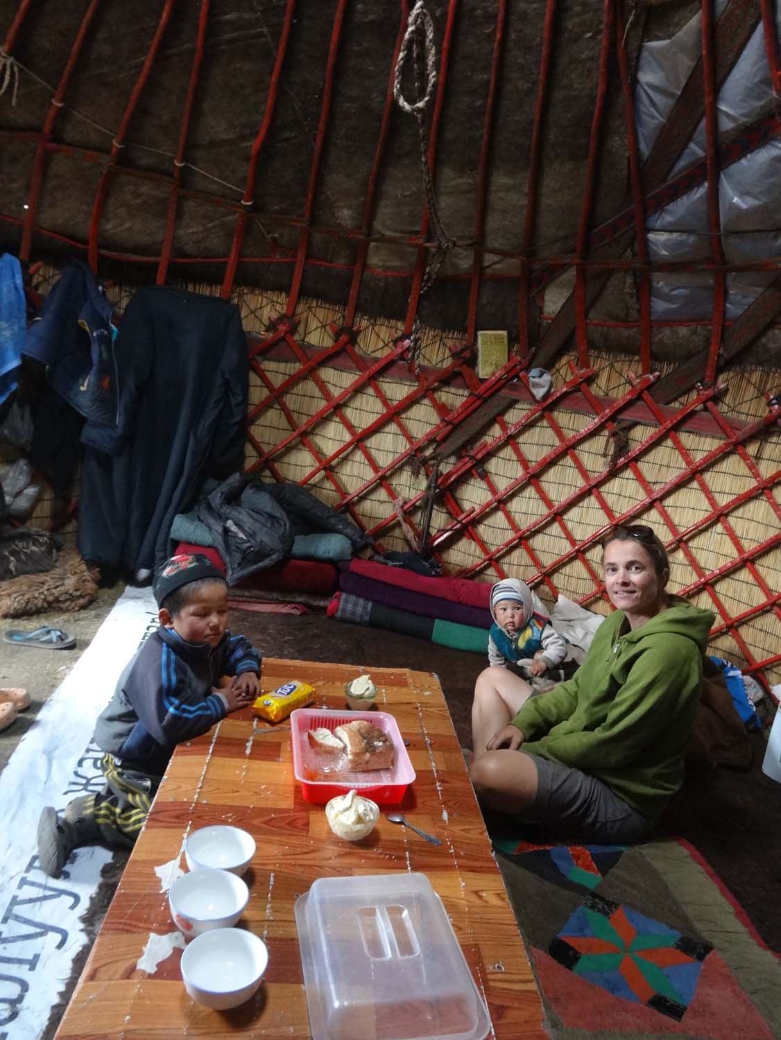inside a Kyrgyz yurt, sitting on the sheepskin