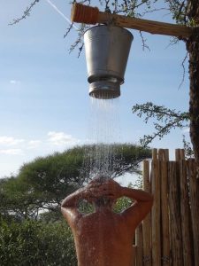 Riet rinsing off in the outdoor shower at Tarangire NP