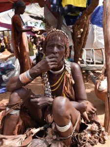 a Hamer lady is trying to sell her wares at a local market