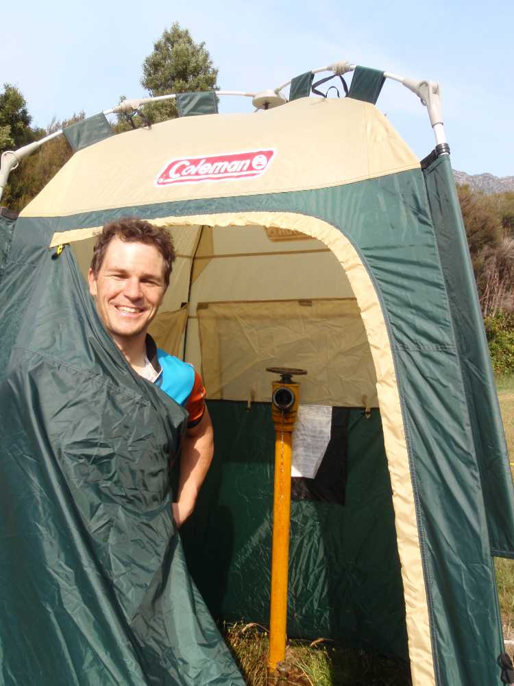 Jon about to have a shower, the tent has been placed around the fire hose outlet - refreshing